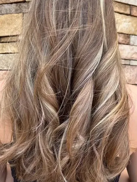 Long layered balayage seen from behind, falling past the waist