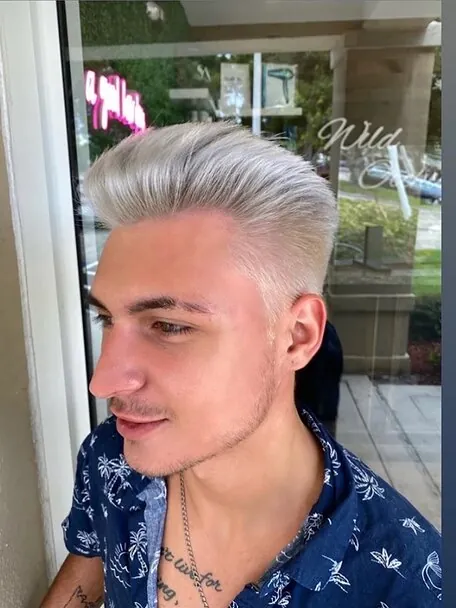 A men's platinum blonde cut, swept back and finished