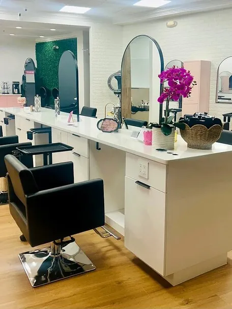Arched mirrors and orchids along the Wild Orchid styling stations
