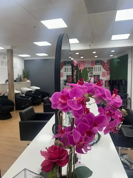 Magenta orchids on the counter between styling stations